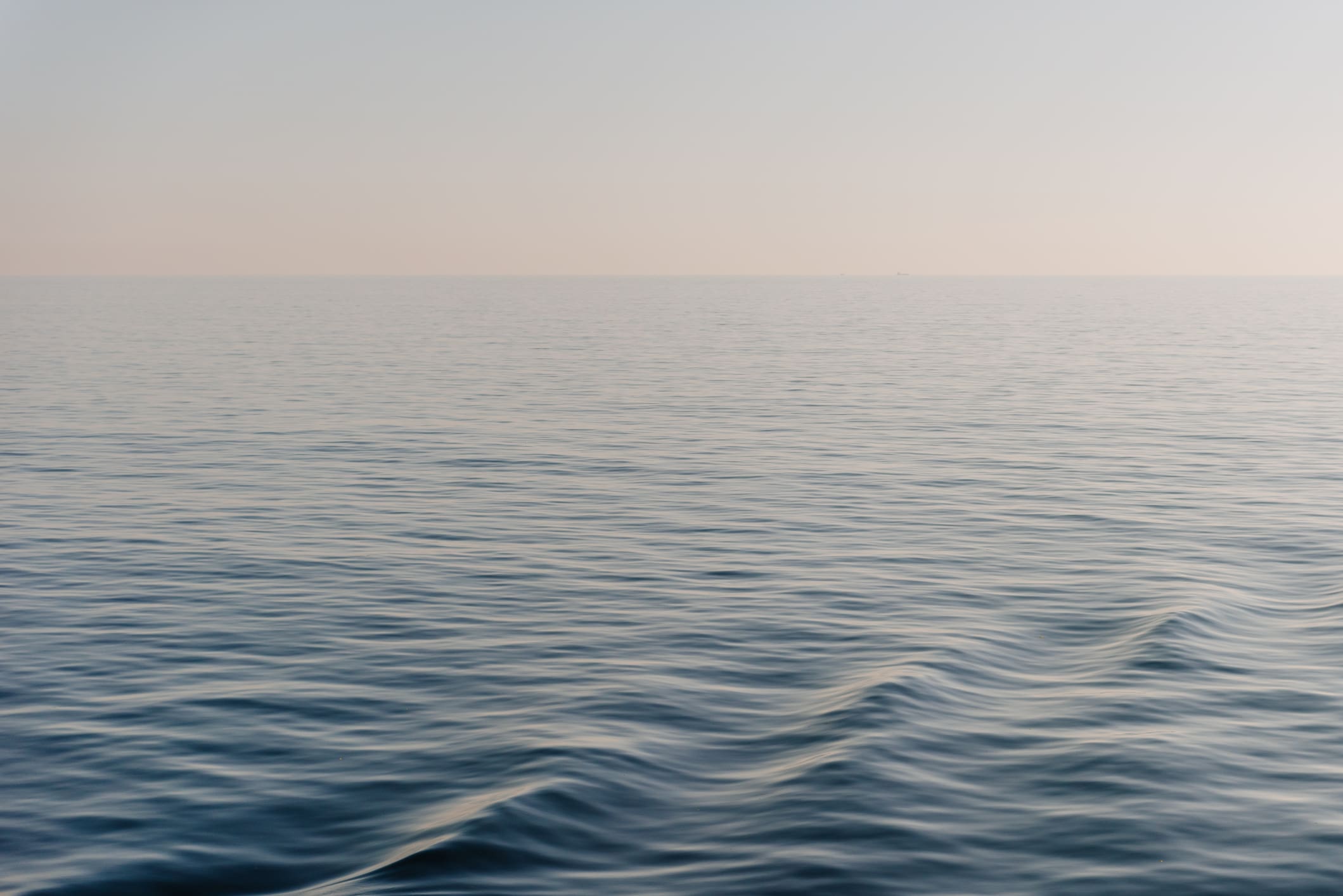 Calm ocean waves under clear sky.
