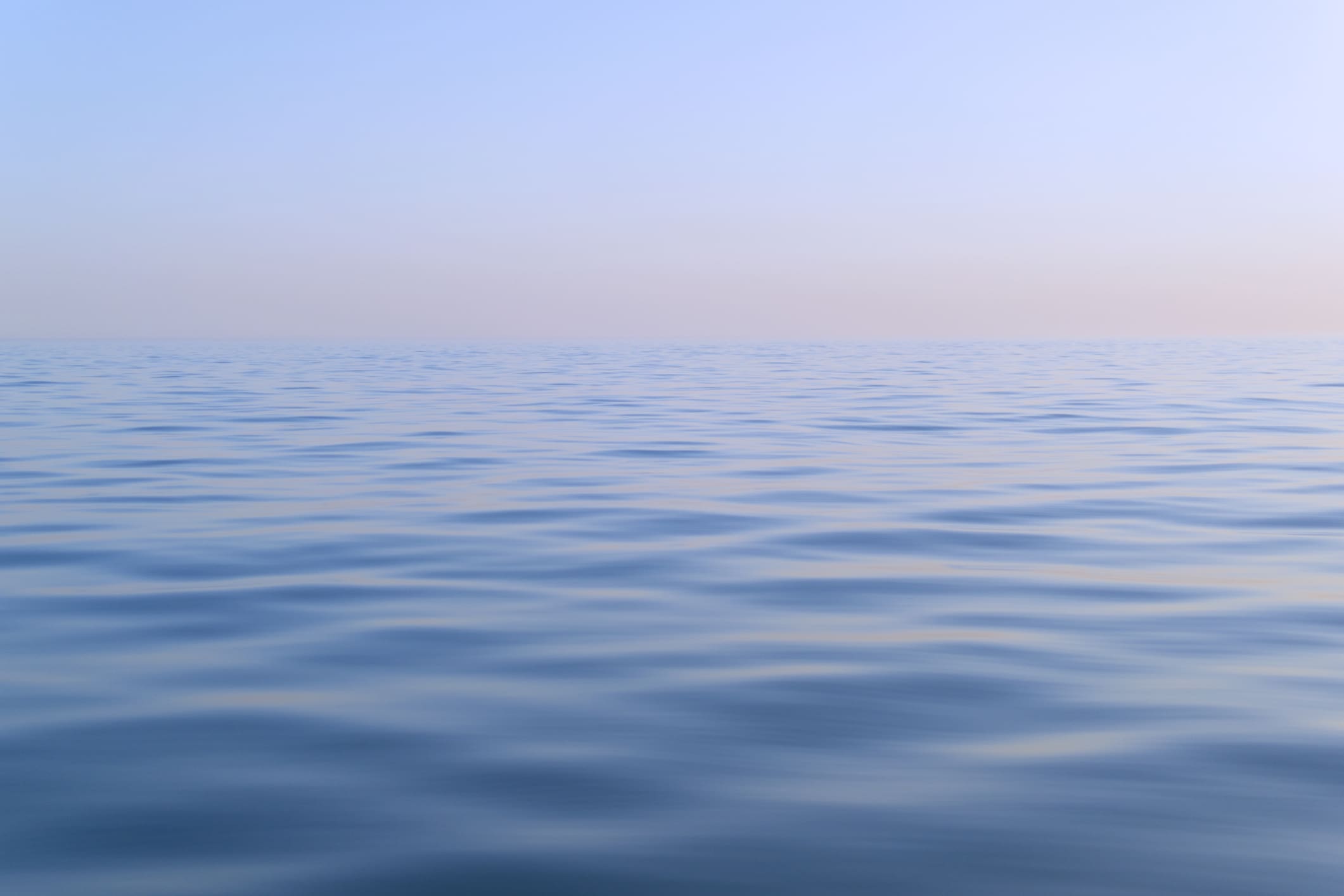 Calm ocean under a clear blue sky.