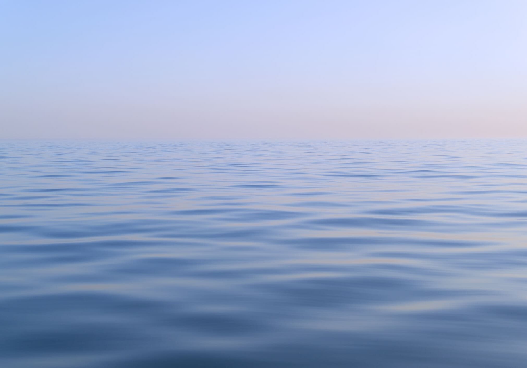 Calm ocean under a clear blue sky.
